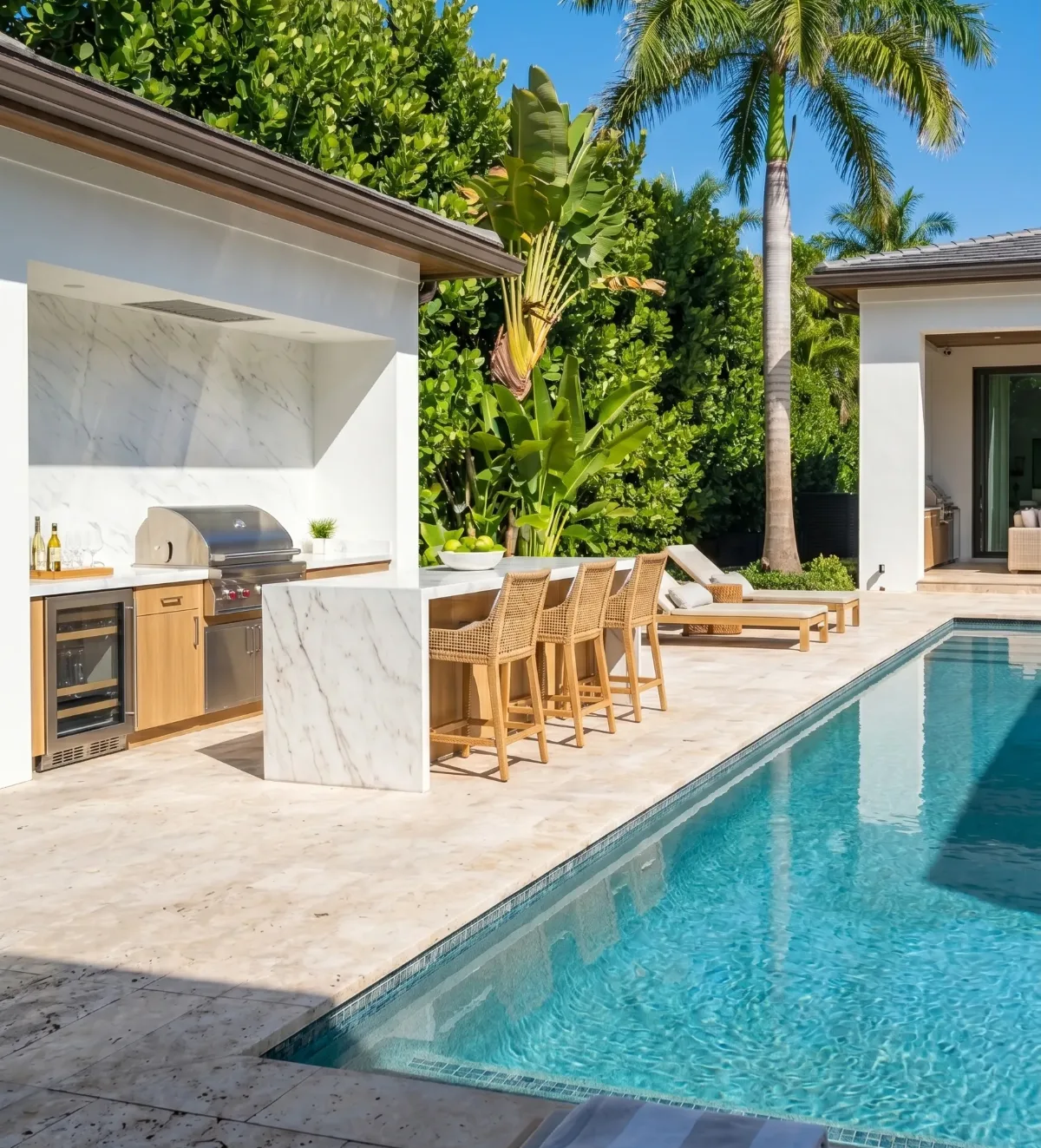 Outdoor kitchen and travertine pool deck hardscaping in South Florida