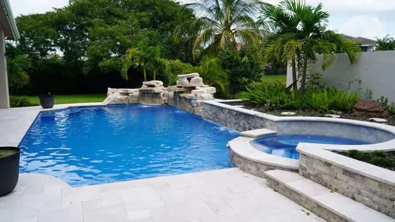 Natural rock waterfall and spa built into a custom pool in South Florida